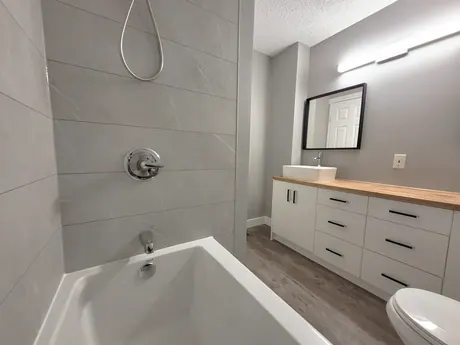 Full bathroom with a wood counter and vessel sink, Calgary