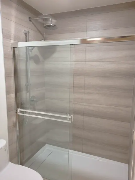 Shower with wood-look tile-less panels and sliding glass doors, Calgary