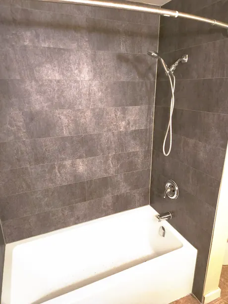 Bathtub surround in dark slate-look tile-less panels, Calgary