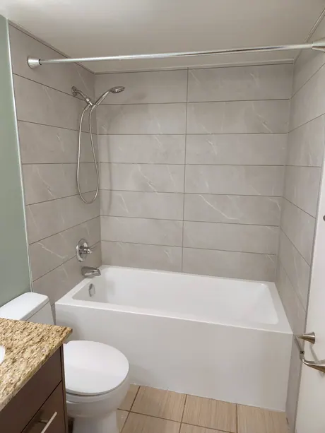 Bathtub surround in grey marble-look tile-less panels, Calgary