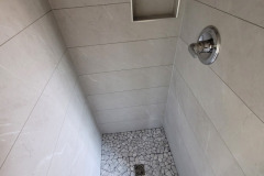 grey panels- tile base-recessed shower